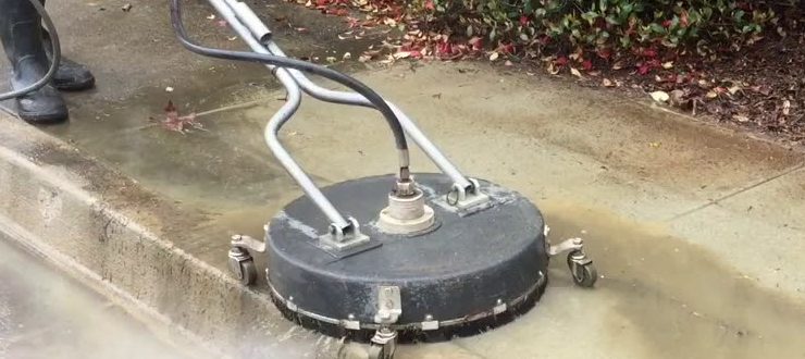 Surface cleaner pressure washing a concrete sidewalk