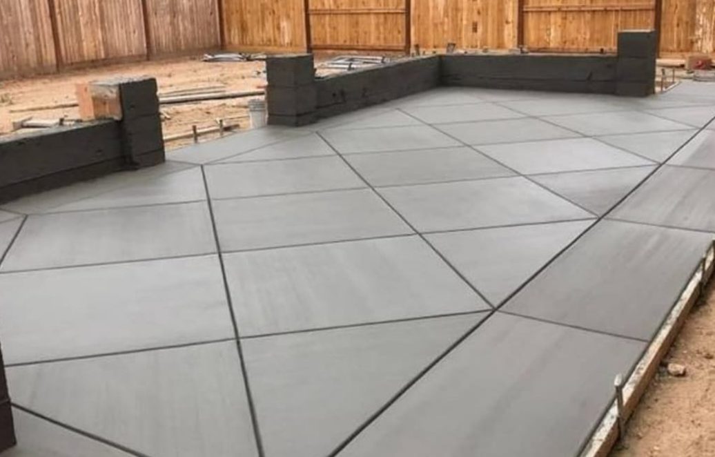 Freshly poured back patio with diagonal control joints